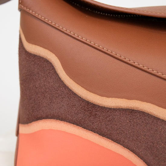 Brown and orange handbag on a light background