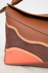 Brown and orange handbag on a light background