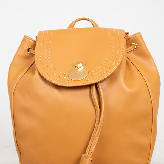 Orange backpack with a gold clasp on a white background