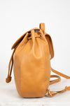 Tan leather bucket bag on a light background