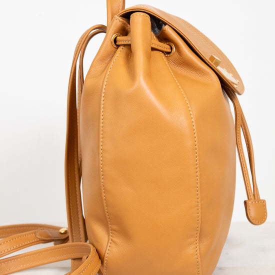 Tan leather backpack on a white background