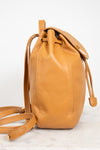 Tan leather backpack on a white background
