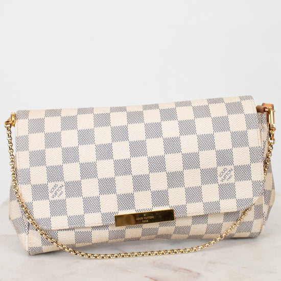 Checkered handbag with gold chain on a light gray background
