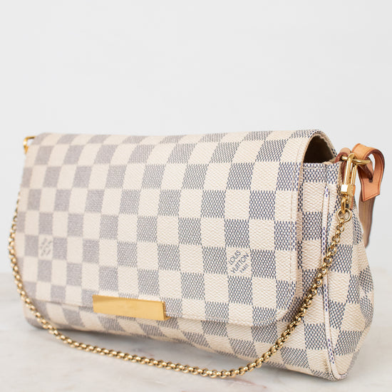 Checkered handbag with gold chain on a white background