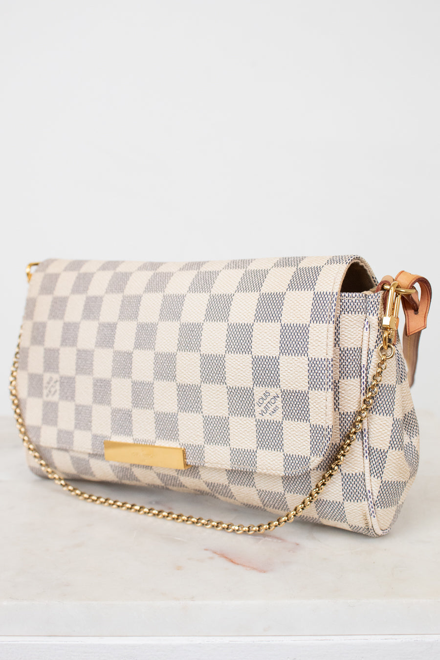 Checkered handbag with gold chain on a white background