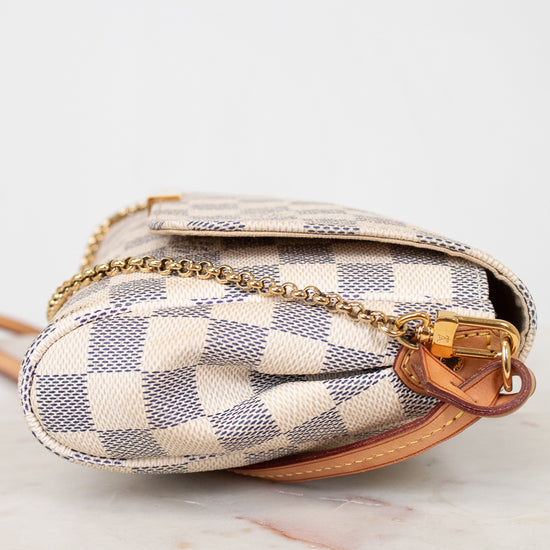 Designer handbag with checkered pattern on a white background