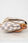 Designer handbag with checkered pattern on a white background