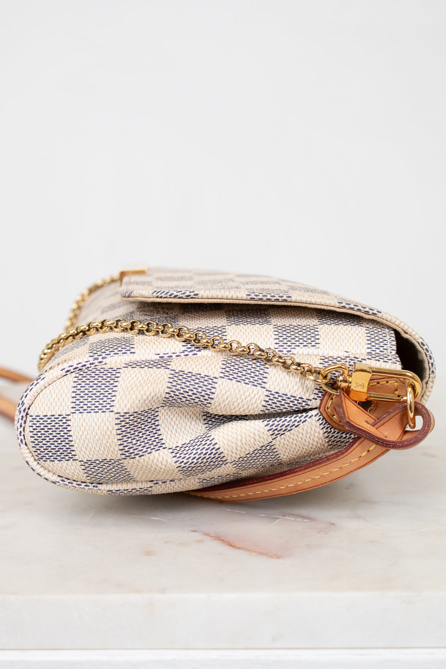 Designer handbag with checkered pattern on a white background