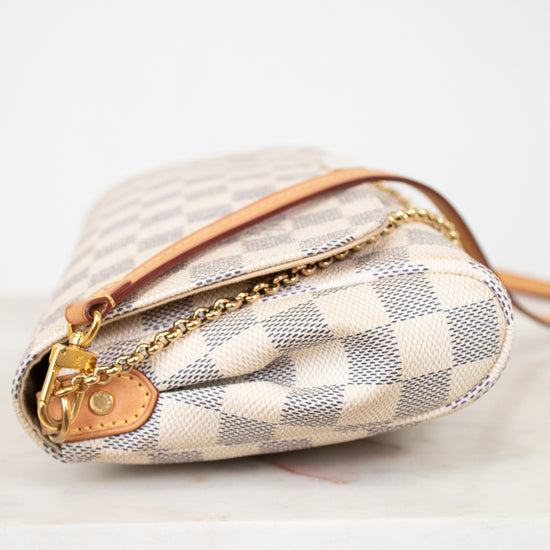 Designer handbag with checkered pattern on a white background