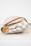 Designer handbag with checkered pattern on a white background