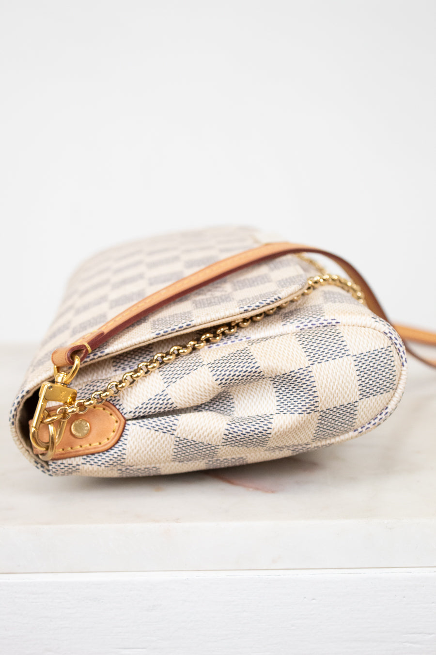 Designer handbag with checkered pattern on a white background