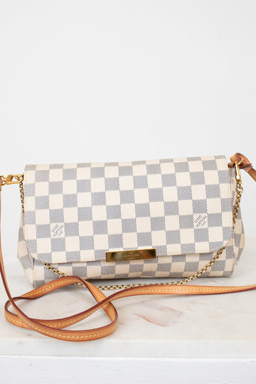 Checkered handbag with a brown strap on a white background