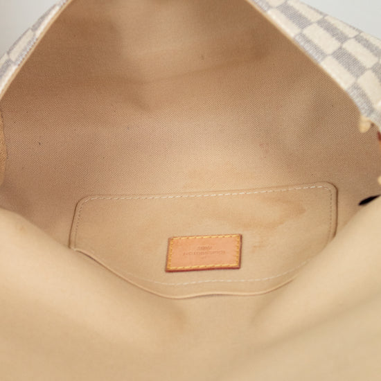 Close-up of a beige interior of a bag with a brand label.