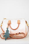 White handbag with brown strap and gold hardware on a white background