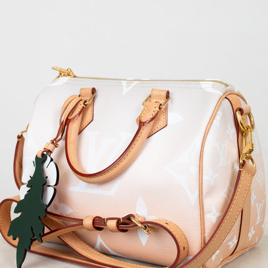 White and tan handbag with brown handles and trim on a white background