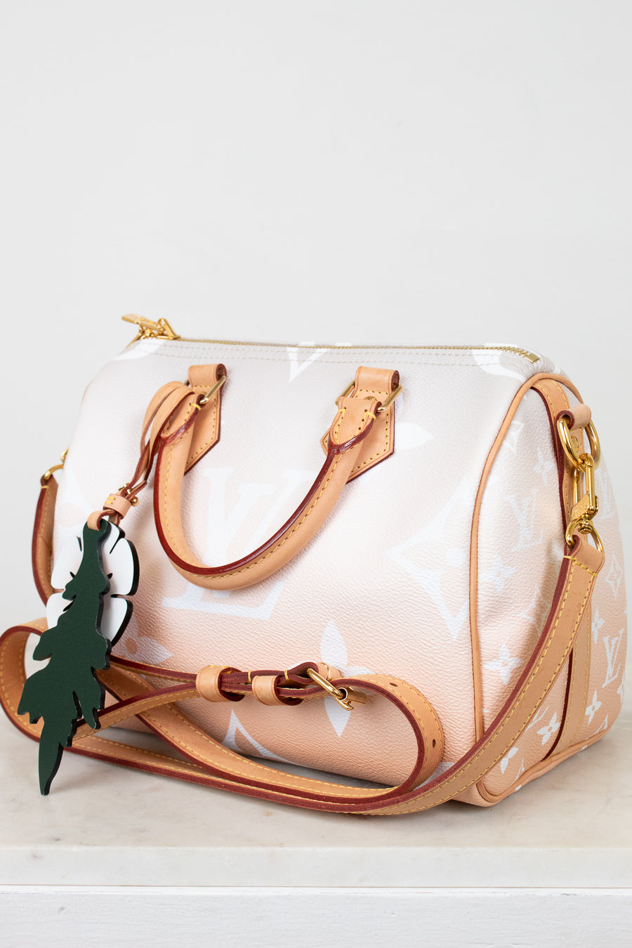 White and tan handbag with brown handles and trim on a white background