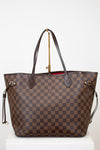 Brown checkered handbag with gold accents on a white background