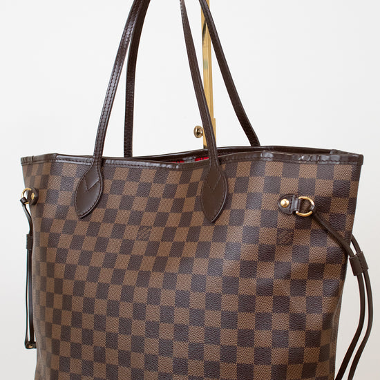 Brown checkered handbag with gold accents on a white background