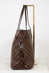 Brown checkered handbag with gold accents on a white background