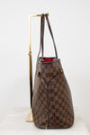 Brown checkered handbag with a gold handle on a white background