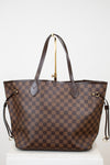 Brown checkered handbag with gold accents on a white background