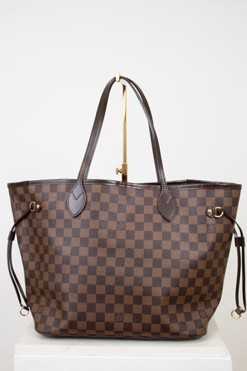 Brown checkered handbag with gold accents on a white background
