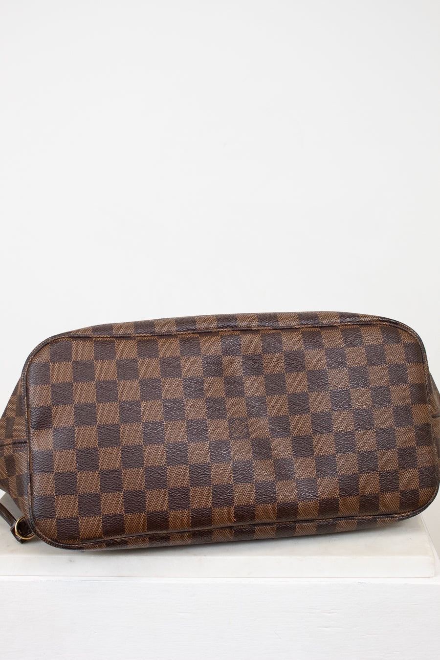Brown checkered handbag on a white background