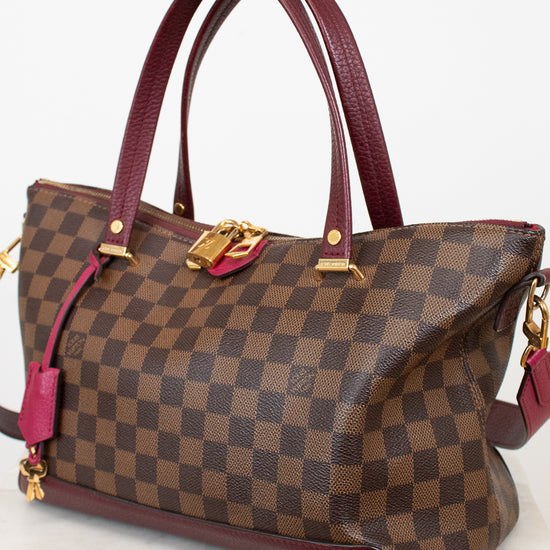 Brown checkered handbag with red accents on a white background