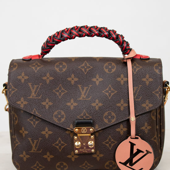 Designer handbag with monogram pattern on a white background