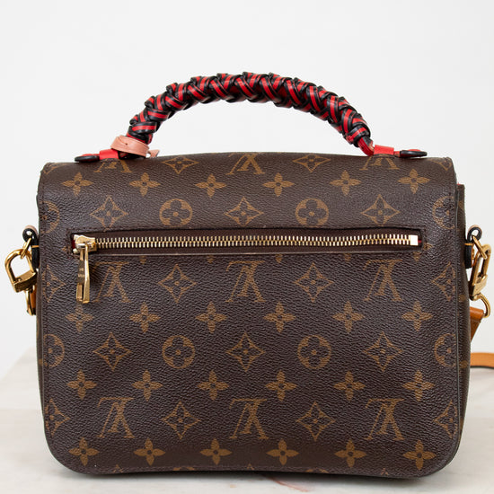 Brown handbag with a monogram pattern on a white background