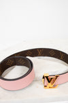 Louis Vuitton belt with pink strap and gold buckle on a white background