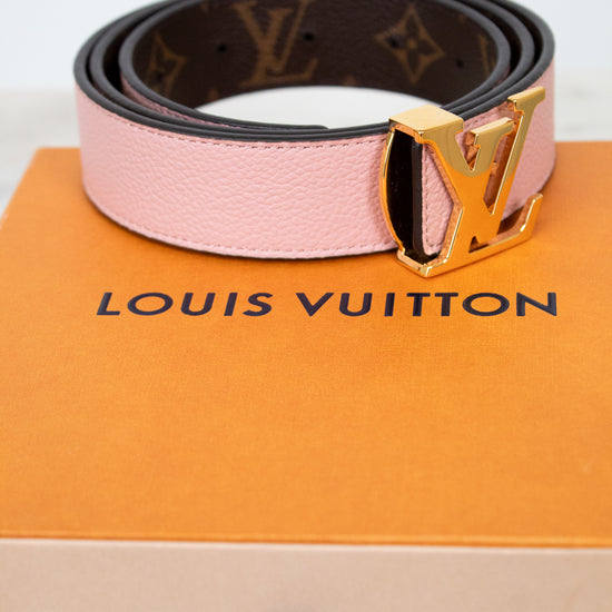 Louis Vuitton belt on a branded box with a white background