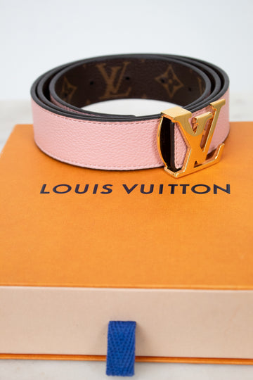 Louis Vuitton belt on a branded box with a white background