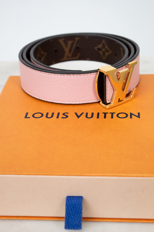 Louis Vuitton belt on a branded box with a white background