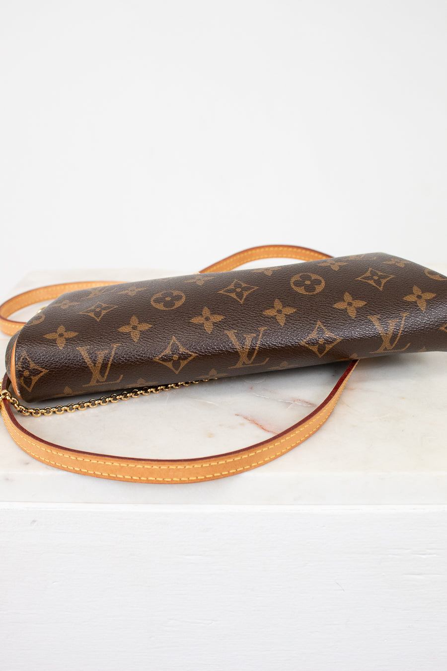 Louis Vuitton monogram handbag on a light background
