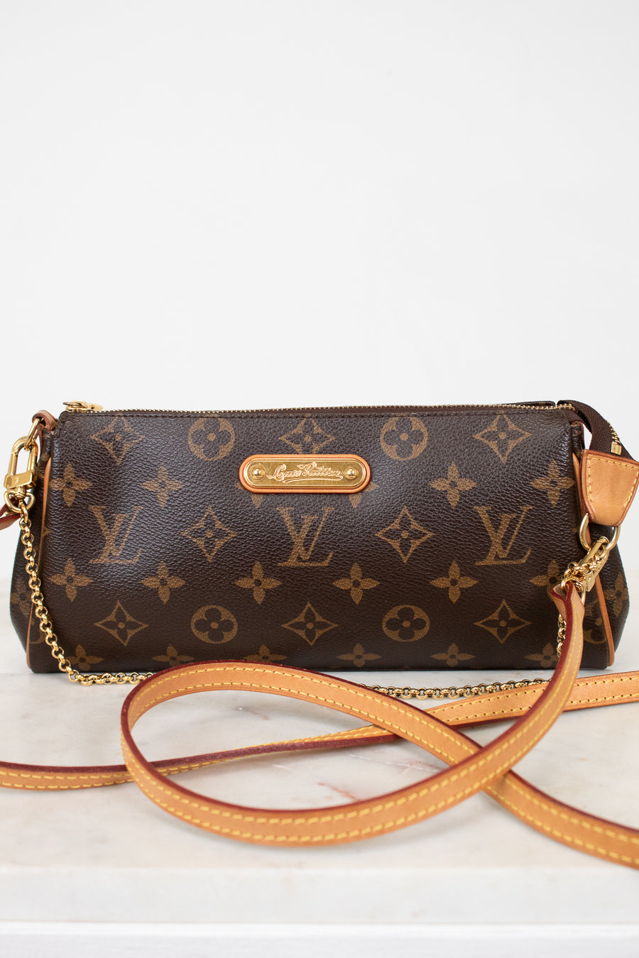 Louis Vuitton handbag with monogram pattern on a light background
