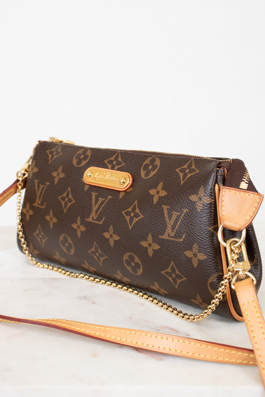 Louis Vuitton handbag with monogram pattern on a light background