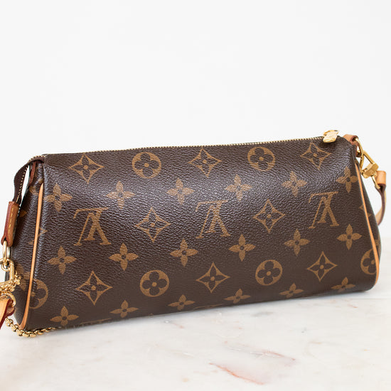 Brown handbag with gold monogram pattern on a white surface