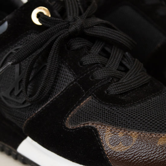 Black sneaker with brown accents on a light background