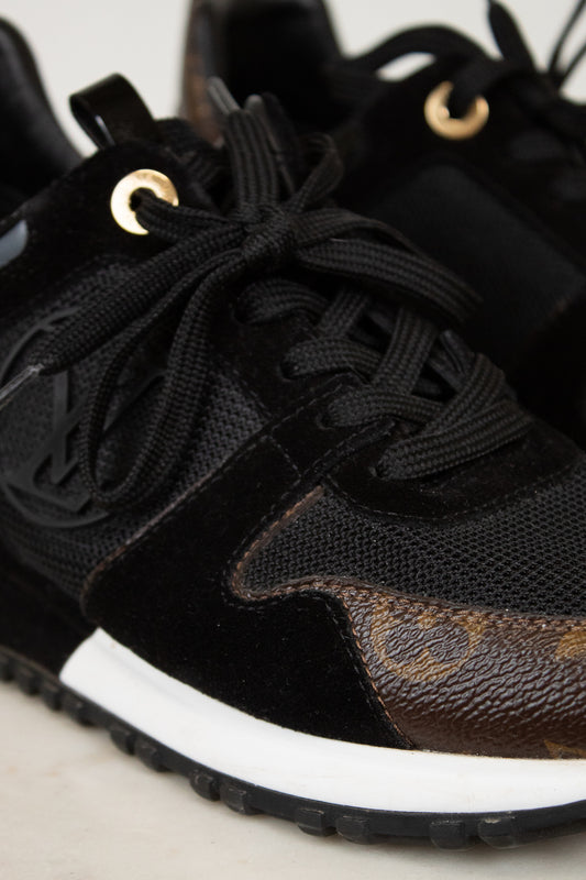 Black sneaker with brown accents on a light background