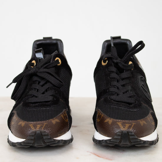 Black sneakers with brown monogram pattern on a white background