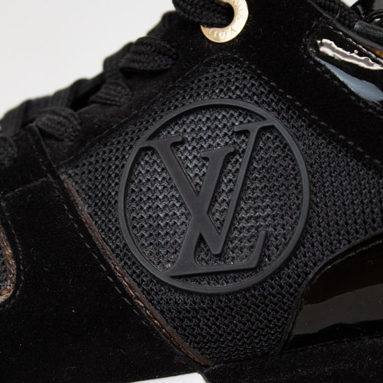 Black sneaker with a brand logo on a white background