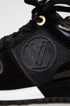 Black sneaker with a brand logo on a white background