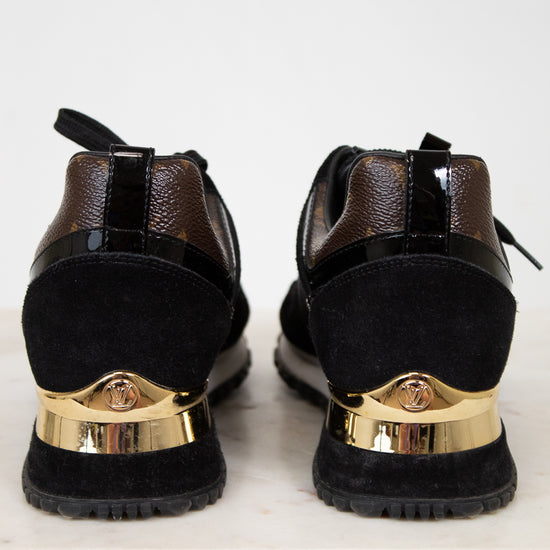 Black shoes with gold accents on a white background