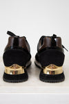Black shoes with gold accents on a white background