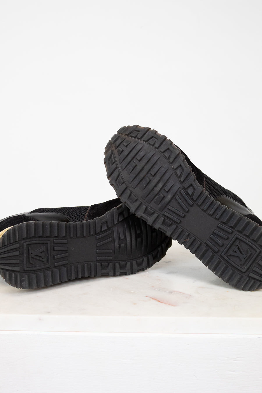 Black shoes with textured soles on a white background