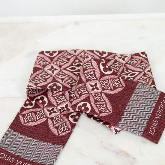 Louis Vuitton scarf with intricate pattern on a marble surface