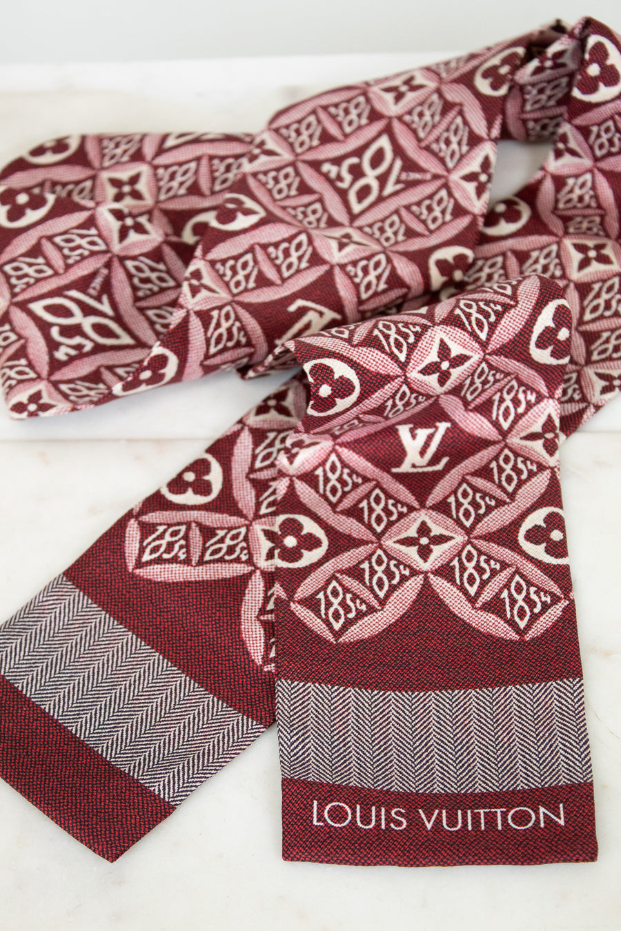 Louis Vuitton scarf with patterned design on a white background