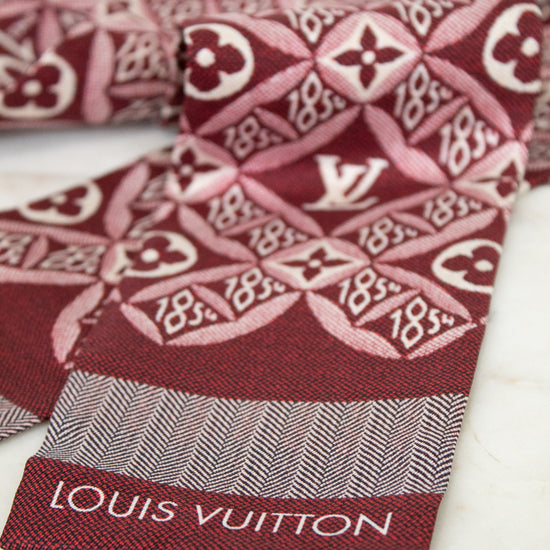 Red and white patterned fabric with Louis Vuitton branding on a white background