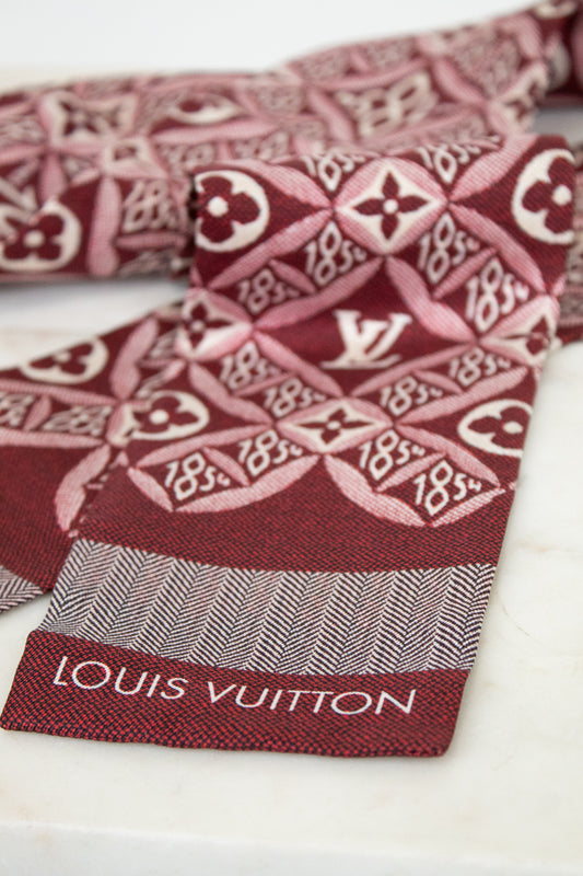 Red and white patterned fabric with Louis Vuitton branding on a white background